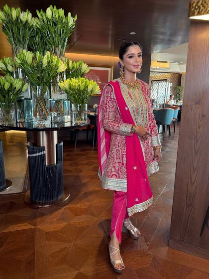 The perfect Anand Karaj or daytime event look. I created a clean, fresh look with a braided bun adorned with colorful flowers.