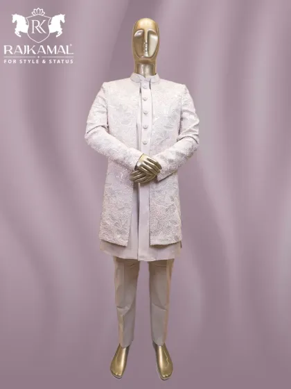 A full mannequin display of a stunning white Indo-Western outfit. The sequined open jacket is paired with a simple kurta and trousers for a look of modern sophistication.