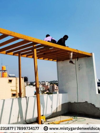 My team at work on top of the pergola frame. Their expertise ensures that every component is installed correctly and safely.