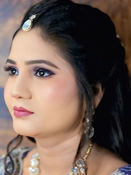 The open-eyed version of this look shows how the purple eyeshadow makes the eyes pop. It's a perfect example of how to wear color in a sophisticated way.