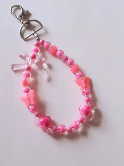 A super cute pink beaded keychain, filled with pink hearts and butterfly charms. This is perfect for anyone who loves the color pink and a girly aesthetic.