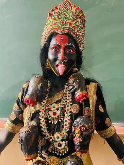 The final transformation into the fierce Goddess Kali. This look features dramatic full-body makeup, intense eye work, and traditional accessories, perfect for a powerful stage performance or mythological photoshoot.