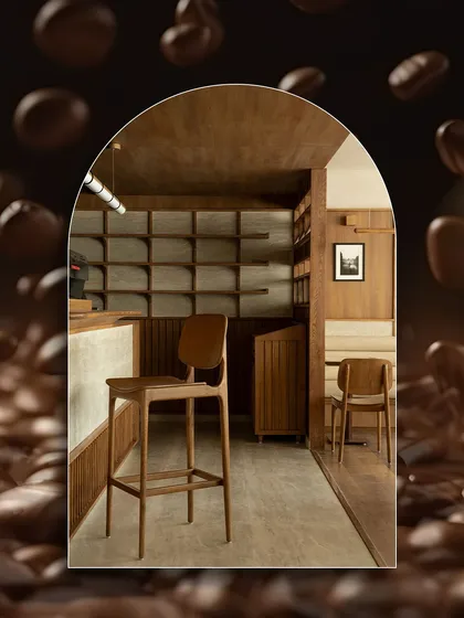 A creative shot of the interior of Quick Brown Fox Coffee Roasters, framed by coffee beans. Our travertine surfaces contribute to the serene, Japandi-inspired design.
