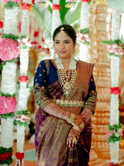 A full shot of the client at her event, looking poised and graceful against the decorated pillars.