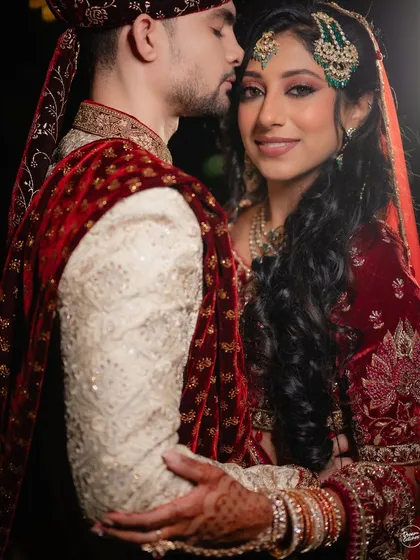 A tender moment from a Nikaah ceremony in Bangalore. The groom's gentle kiss and the bride's serene expression capture the love and solemnity of the occasion.