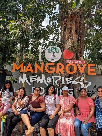 Posing at the "I Love Mangrove Memories" sign in Kerala. These unique ecosystems are a highlight of our trips.