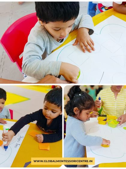 A group of children works together on a large 'shapes tree' poster, learning about collaboration and spatial arrangement while reinforcing their knowledge of geometry.