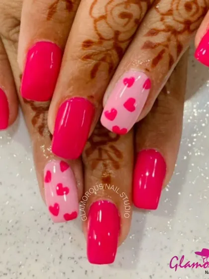 Pretty in pink, this lovely set combines solid bright pink nails with accent nails featuring a lighter pink base covered in tiny pink and red hearts.