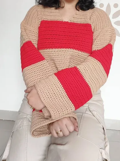 A relaxed, seated view of the Cotton Candy Sweater.