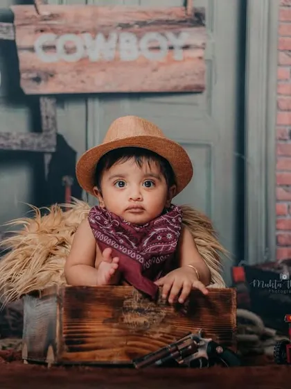 Our 6-month-old cowboy is surveying his ranch. The '1/2' sign marks his half-birthday milestone in style.