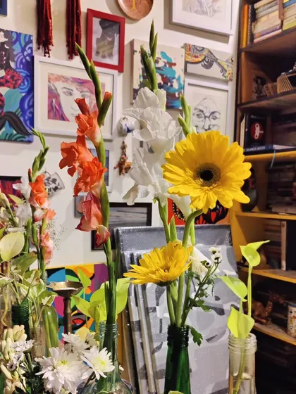 Flowers and art coexisting in our creative space.