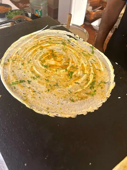 A paper-thin dosa being prepared at a live counter for a Republic Day brunch. This is a fantastic option for morning events, offering a light yet satisfying South Indian delicacy.