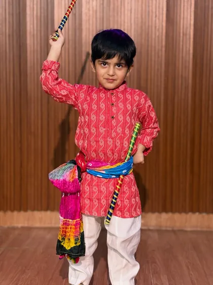 Boys are an integral part of our Garba and Dandiya classes. This young dancer looks sharp and ready in his red kurta and colorful accessories.