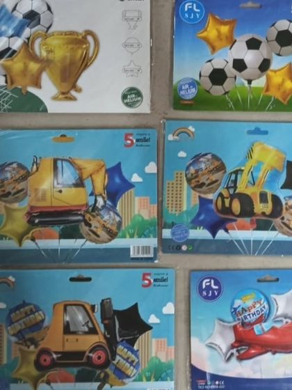For kids who love vehicles and sports, I have balloon sets featuring soccer balls, trophies, construction vehicles like excavators, and airplanes.