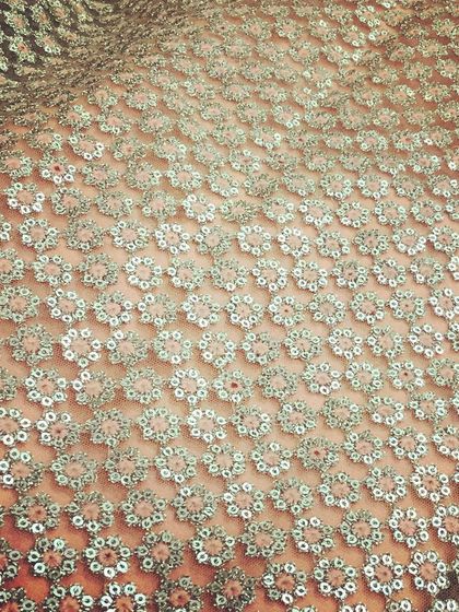 A full sheet of delicate sequin fabric. This material is perfect for adding glamour and sparkle to gowns, lehengas, and blouses, and it catches the light beautifully for any evening event.