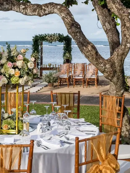 We create unforgettable moments in breathtaking settings. This image showcases an elegant wedding table setup on a serene beach, demonstrating our ability to integrate exquisite catering and decor for any destination event.