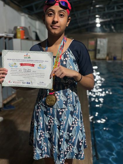 Our girl Pihu with her gold medal for the 50m breaststroke at Talkatora stadium. Her victory is a testament to her consistent effort and training.