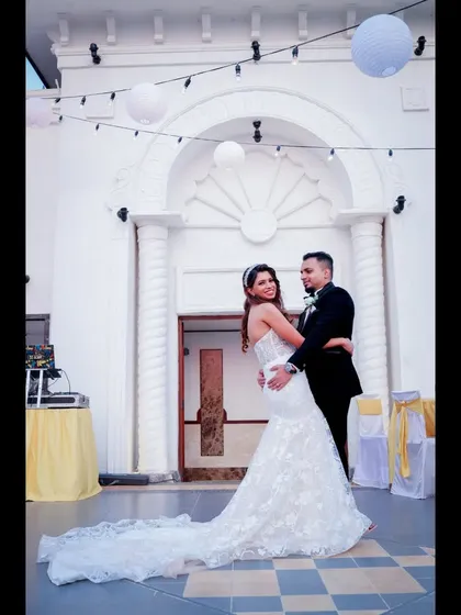 A beautiful portrait of a bride and groom after their church wedding. The classic pose against the white architecture of the venue creates a timeless and elegant wedding photograph.