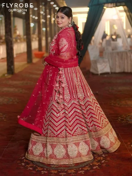 A back view of this stunning designer lehenga, showcasing the detailed embroidery and the perfect fall of the fabric. Every angle is your best angle.