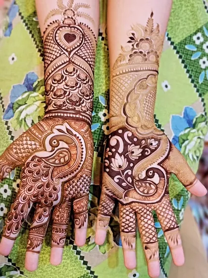 This design features a large peacock on one hand and a floral paisley pattern on the other. The heart motif at the top adds a touch of modern romance.