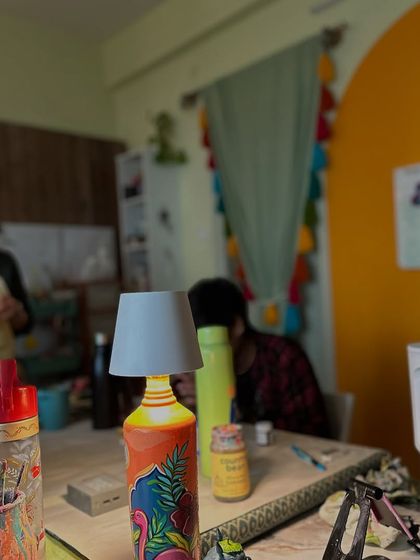 A candid shot of our studio during a busy day. You can see a hand painted lamp in the foreground, adding to the creative clutter.