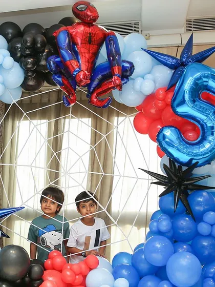 The birthday boys posing inside their very own Spider-Man web. I love creating interactive elements that make the party even more fun.