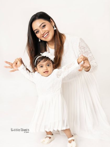 More fun with this mother-daughter duo. Their playful poses and matching white outfits create a series of lighthearted and joyful portraits.