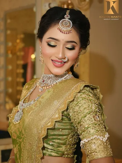 A beautiful South Indian bridal look in a green silk saree. The makeup features golden shimmery eyes and a radiant base to complement the diamond jewelry.