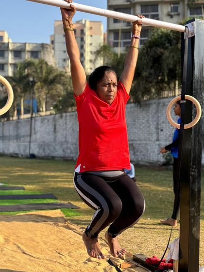 Holding strong at the top of a pull-up. This demonstrates incredible upper body and grip strength, built through consistent training and hard work.