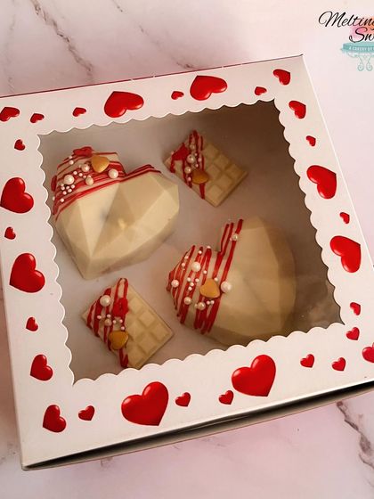 These geometric smash hearts were a popular part of our Valentine's Day collection. Each white chocolate heart is decorated with red drizzle and sprinkles and can be filled with a surprise.