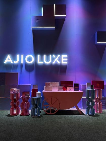 The modern, geometric backdrop with integrated lighting for Ajio Luxe created a futuristic feel. The glowing brand name and colorful props made this a central, eye-catching feature of the event.