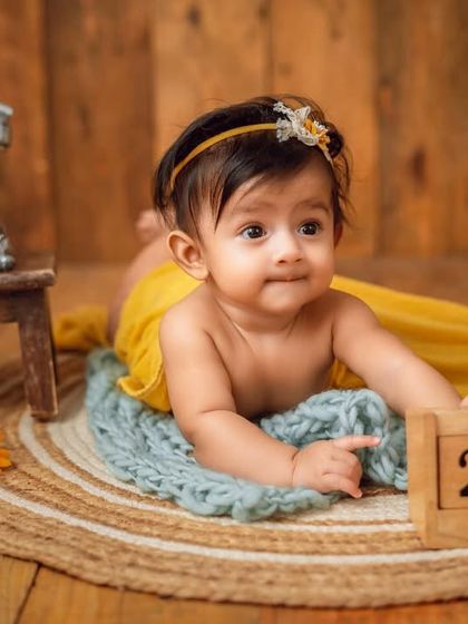 Marking the date. This sweet newborn portrait includes a calendar block to remember the special day of the photoshoot.