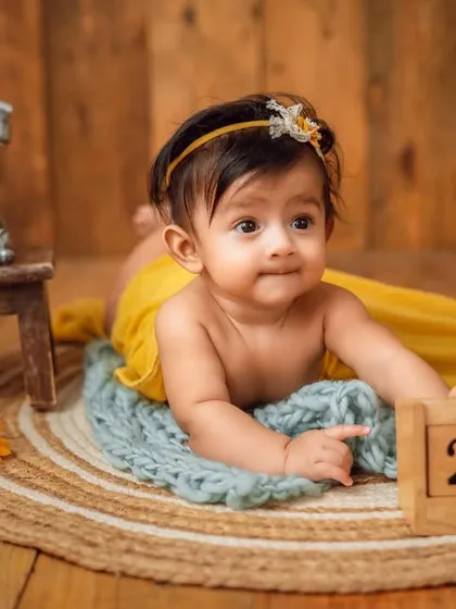 Marking the date. This sweet newborn portrait includes a calendar block to remember the special day of the photoshoot.