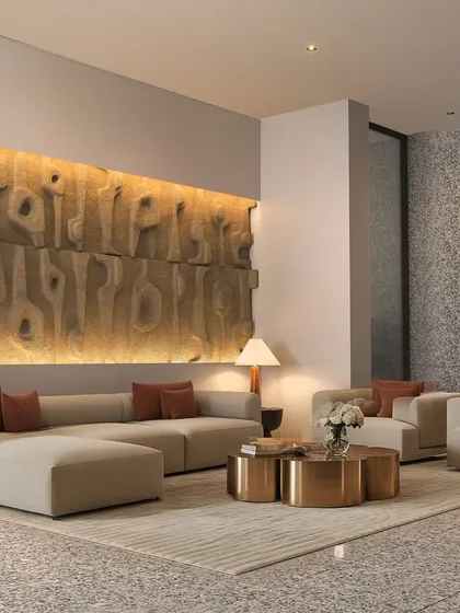 The interior of the lobby at Gulnaar Zenium, featuring a textured art wall, modern furniture, and warm lighting to create a welcoming first impression.