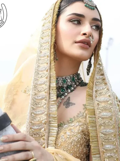 A stunning close-up of a model in a bridal veil, with the soft features of a horse beside her.