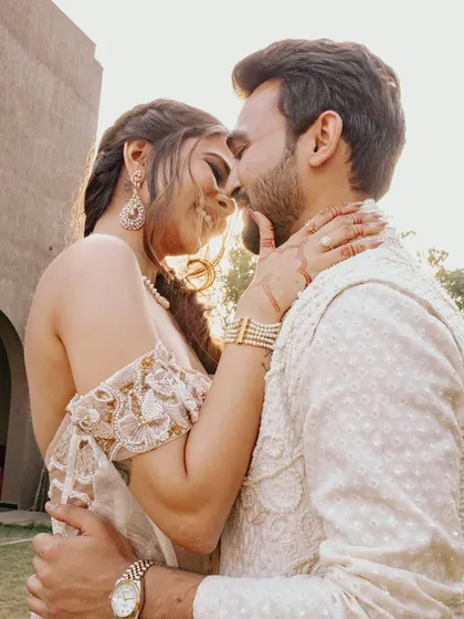 An intimate and romantic shot. The bride's makeup is kept soft and glowing, allowing the emotion of the moment to be the main focus.
