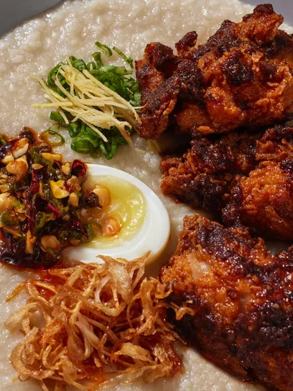 A close-up of the toppings on our Hot Fried Chicken Congee, showing the contrast of textures and flavors.