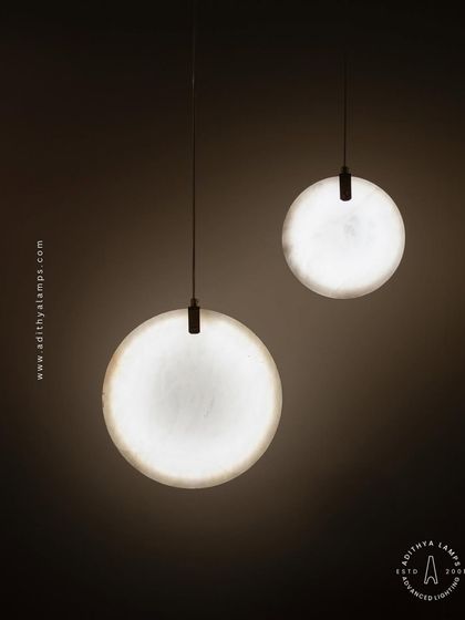 Showcasing our disc-shaped marble pendants. The light emanates softly through the thin slice of natural marble, revealing its unique veining. These fixtures are available in different shapes and look stunning hung in pairs or trios.