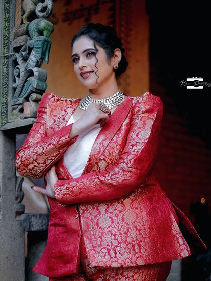 A closer look at the red brocade pantsuit, showing the rich texture of the fabric and the sharp cut of the lapels. I paired it with a simple white top to let the suit be the star of the outfit.