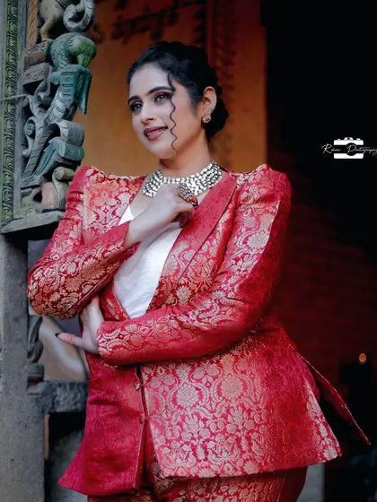 A closer look at the red brocade pantsuit, showing the rich texture of the fabric and the sharp cut of the lapels. I paired it with a simple white top to let the suit be the star of the outfit.