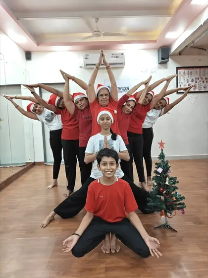 A beautiful star-shaped group pose by our students, including children, for Christmas. Our celebrations are inclusive and fun for all ages.