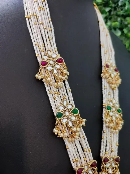 A detailed shot of the pearl strands and the colorful kundan work that makes this rani haar set so special.