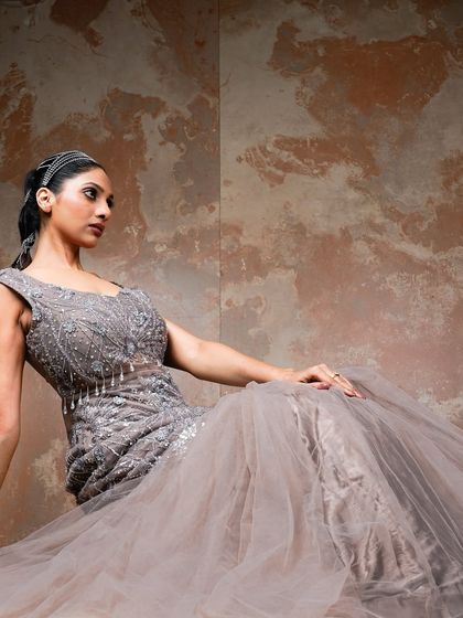 A seated pose that offers a different perspective on the gown. This shot highlights the detailed bodice and creates a feeling of relaxed glamour, perfect for an editorial story.