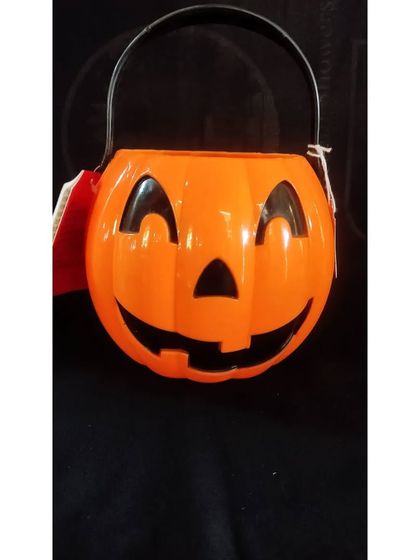 A friendly-faced pumpkin pail, perfect for younger children who are going trick-or-treating. It's more sweet than spooky.