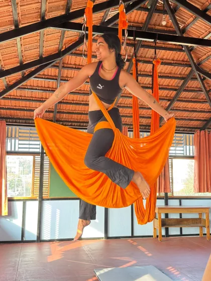 A student in our Aerial TTC holds a beautiful skirt pose, showcasing the grace and artistry that can be achieved with the hammock.