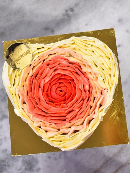 An overhead view of the heart-shaped rosette cake, showcasing the intricate petal work and the beautiful color gradient.