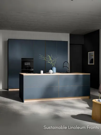 This kitchen is defined by quiet luxury and conscious craftsmanship, with sustainable linoleum fronts and a light oak worktop providing a beautiful contrast.