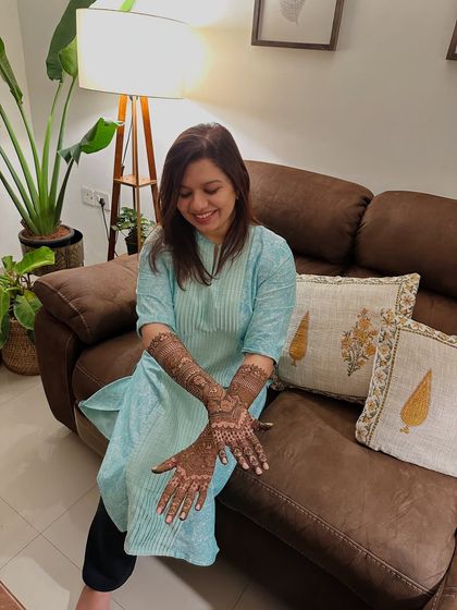 Another happy shot of the bride, showcasing her beautiful and detailed henna art.