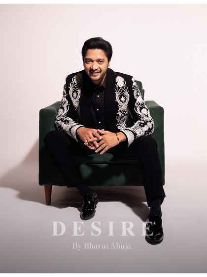 A picture of sophisticated ease. The way the jacket sits, even in a relaxed pose, is a testament to its bespoke tailoring. Every line is crafted to perfection for a flawless fit.