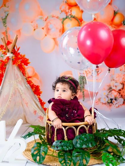 Another beautiful shot from the "Halfway to One" session, showing the full setup with the teepee and autumn-colored balloons.